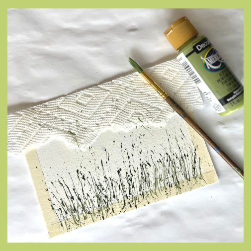 Use a paper towel to cover parts of painting you don't want splatters for your splattered flower garden painting.