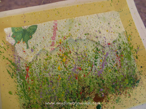 Use a paper towel to cover parts of painting you don't want splattered for your splattered flower garden painting-myflowerjournal.com